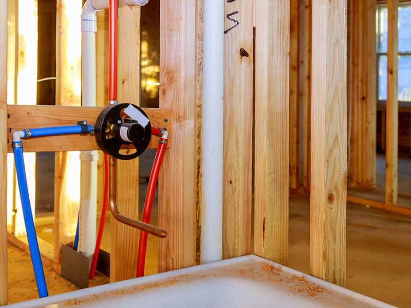 Bathroom remodel showing under plumbing work connecting installation shower faucet