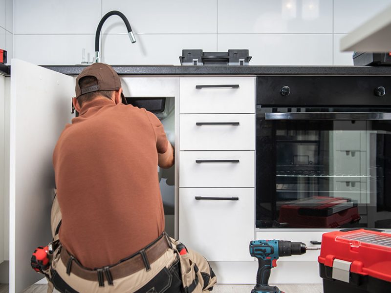 Plumbing Technician Finishing Kitchen Sink Pipeline Installation. JPW RESIDENTIAL PLUMBING IN GLENVIEW IL best chicago plumbers, chicago plumbing